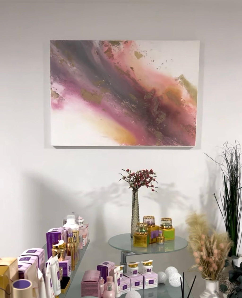 Flow above a round side table with flowers in a styled space