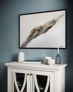 Bedrock on a deep teal wall above a white display cabinet.