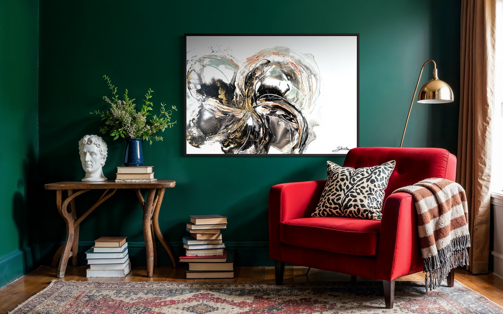 Unfold on a deep green wall above a side table, beside a red armchair