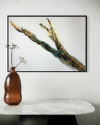 Rooted 1 framed in black above a marble surface with an amber glass vase