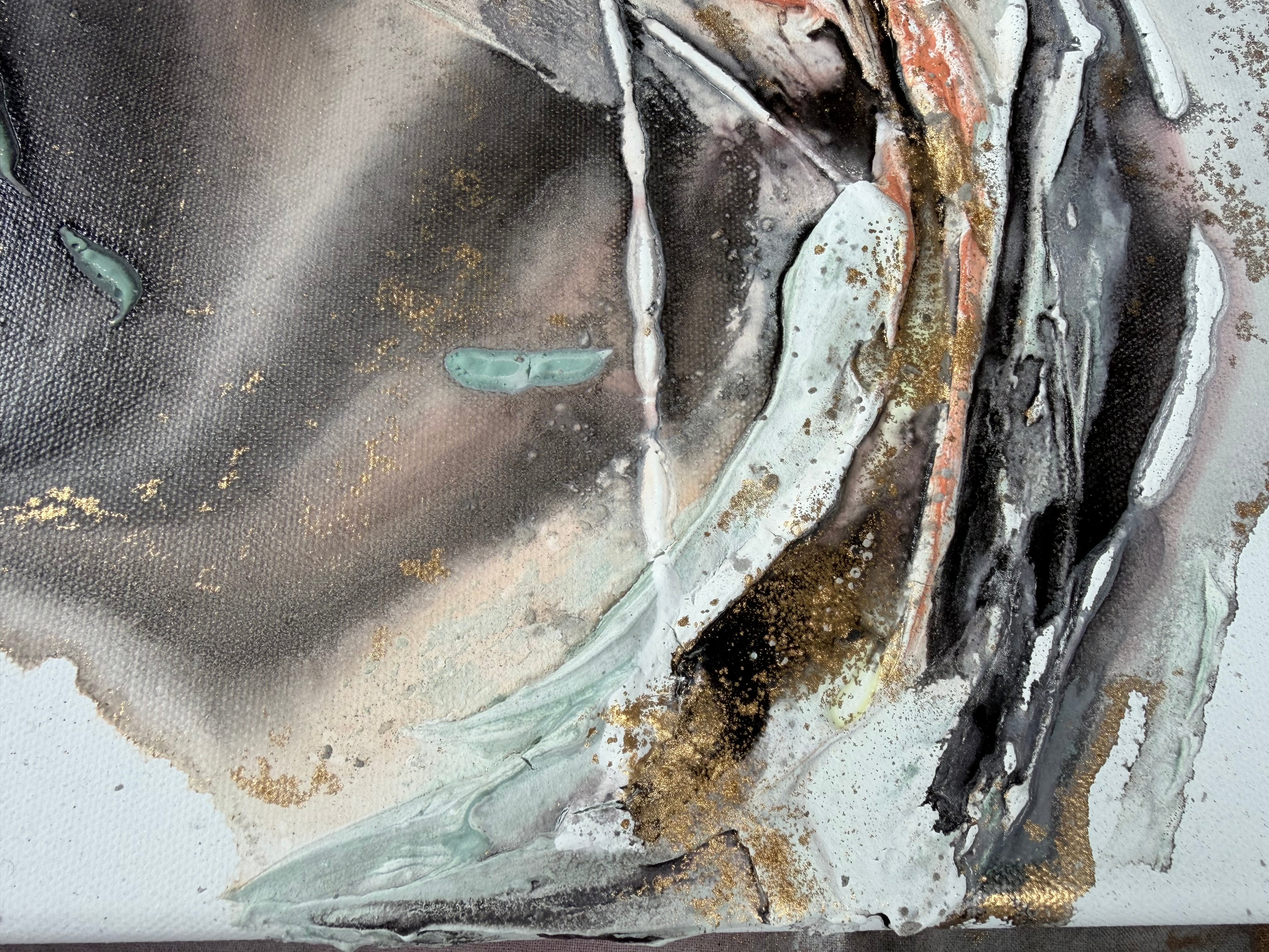 Close-up of pale grey and green with gold and black in Unfold