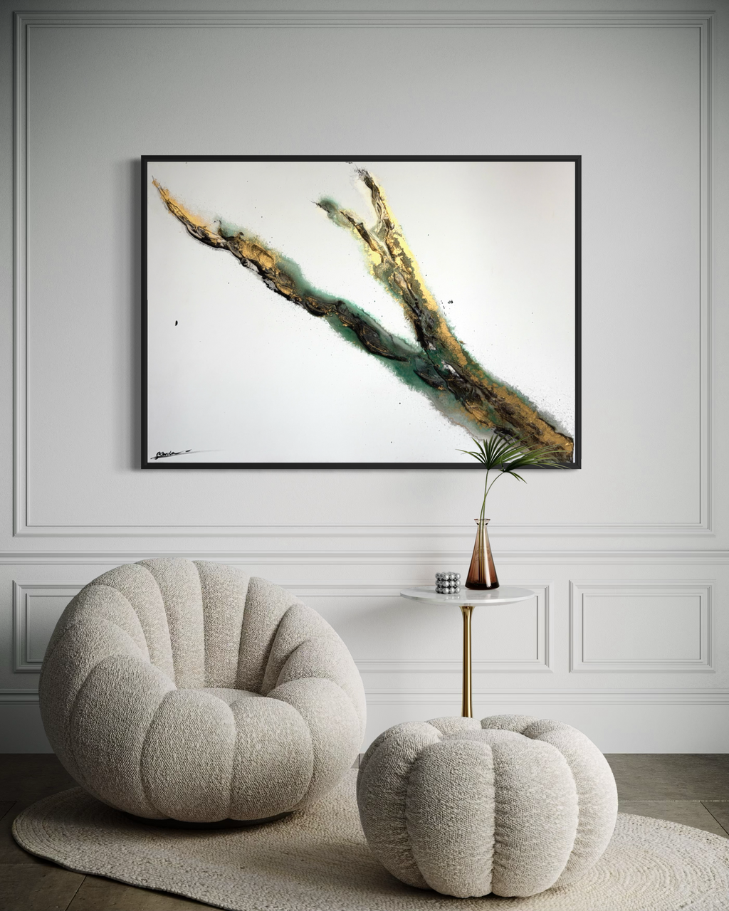 Rooted 1 framed in black on a panelled wall above a bouclé chair and pouf
