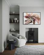 Wildflower framed in black, hanging beside a wood burner in a pale living room with a bouclé armchair