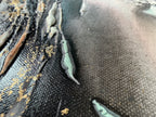Surface detail of Unfold with a pale green ridge standing off the black ground