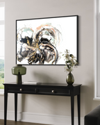 Unfold above a black console with a green lamp and dried flowers