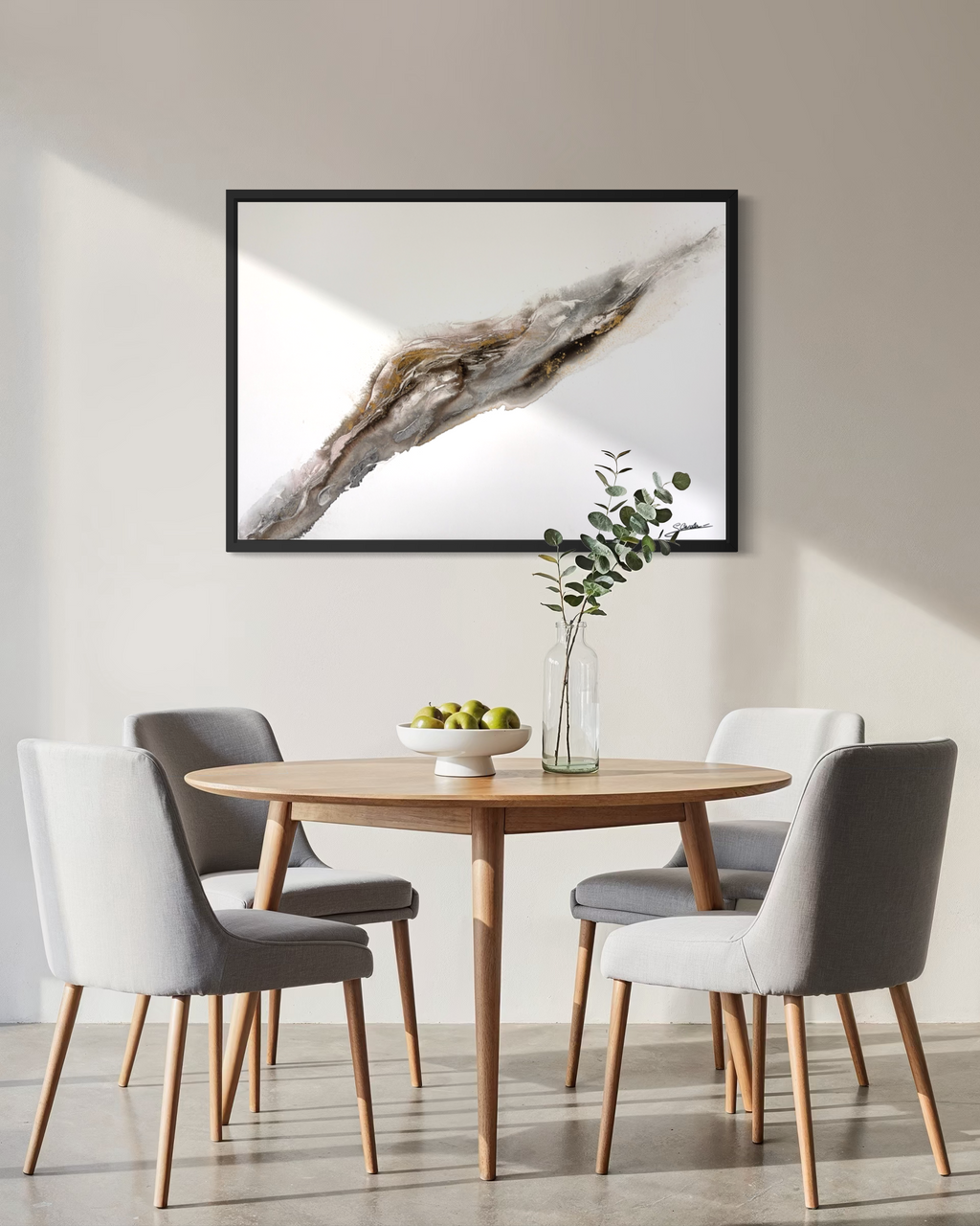 Bedrock hanging above a round dining table with grey chairs and a sprig of eucalyptus.