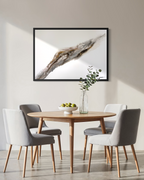Bedrock hanging above a round dining table with grey chairs and a sprig of eucalyptus.
