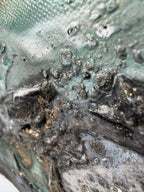 Macro of silver, black and gold layers in Rooted 2