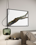 Rooted 2 framed in black above a bed, beside a green glass pendant lamp