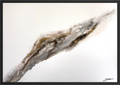 Bedrock, a textured abstract painting in a black floater frame. A diagonal seam of grey, brown, black and gold runs across an open white field.