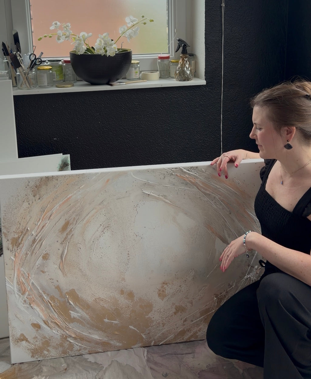 Artist Stefanie Carola beside her painting Peace, showing its scale