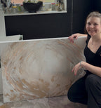Stefanie Carola next to her finished painting Peace