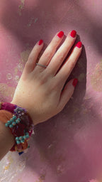 Video of a hand resting on the textured surface of Flow, art meant to be touched