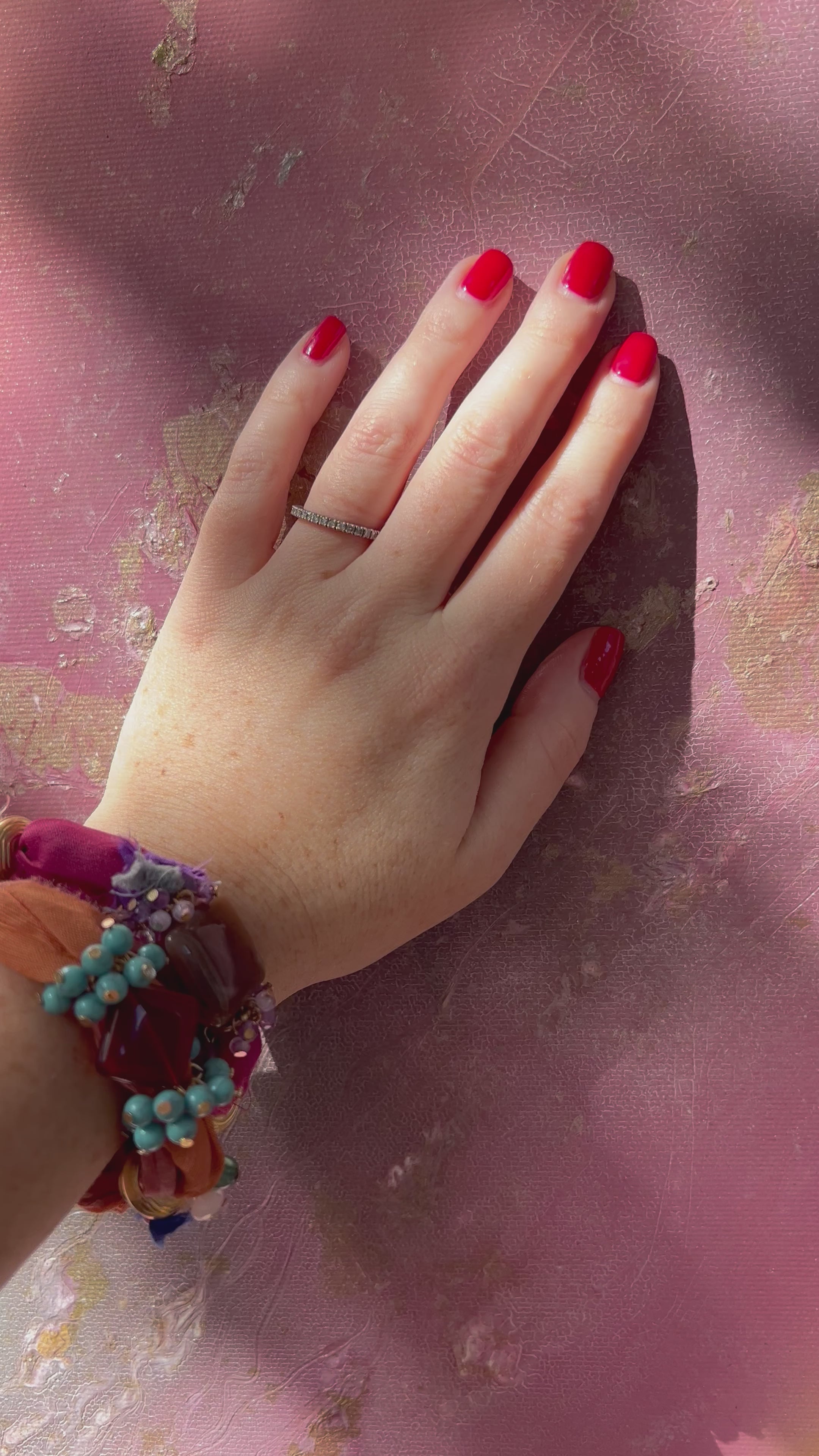 Video of a hand resting on the textured surface of Flow, art meant to be touched