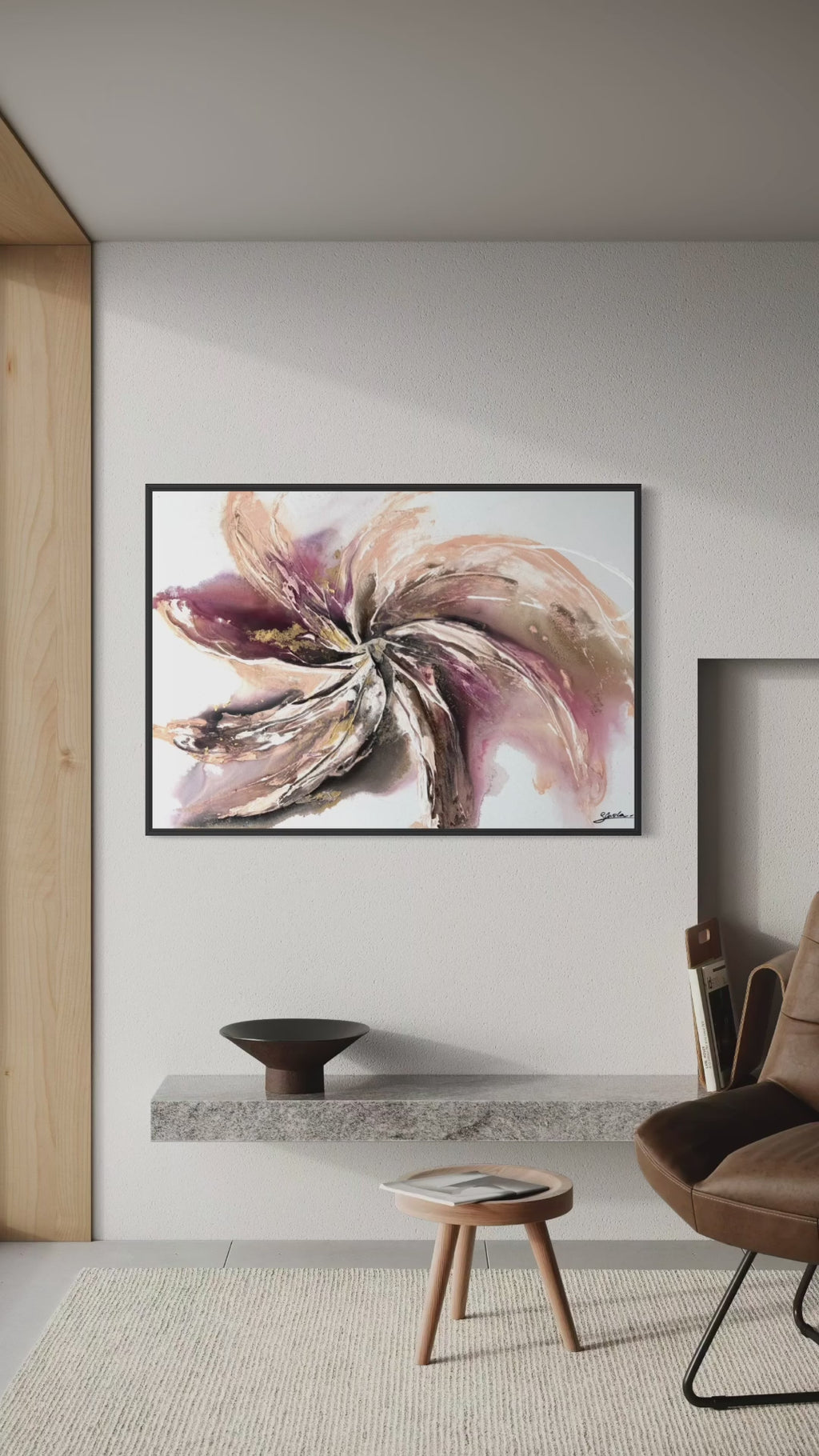 Video panning across Wildflower on a white wall beside a brown leather chair