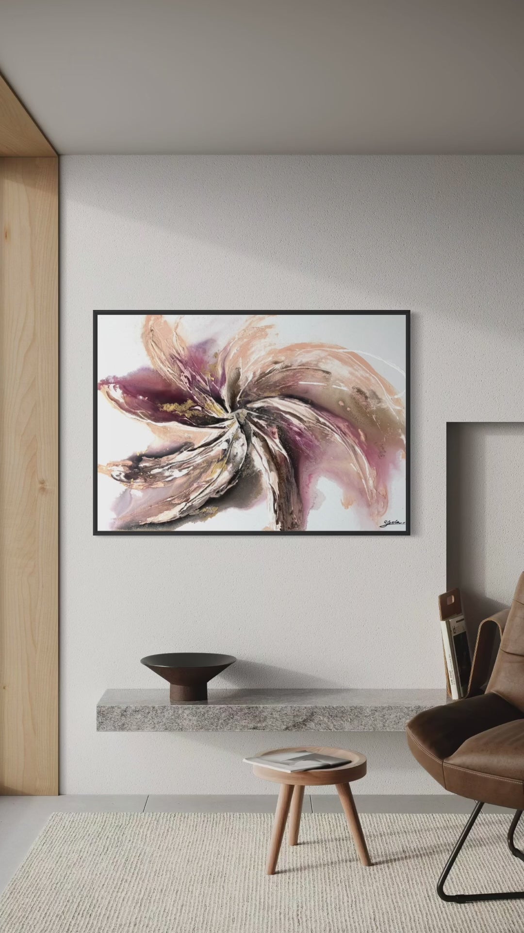Video panning across Wildflower on a white wall beside a brown leather chair